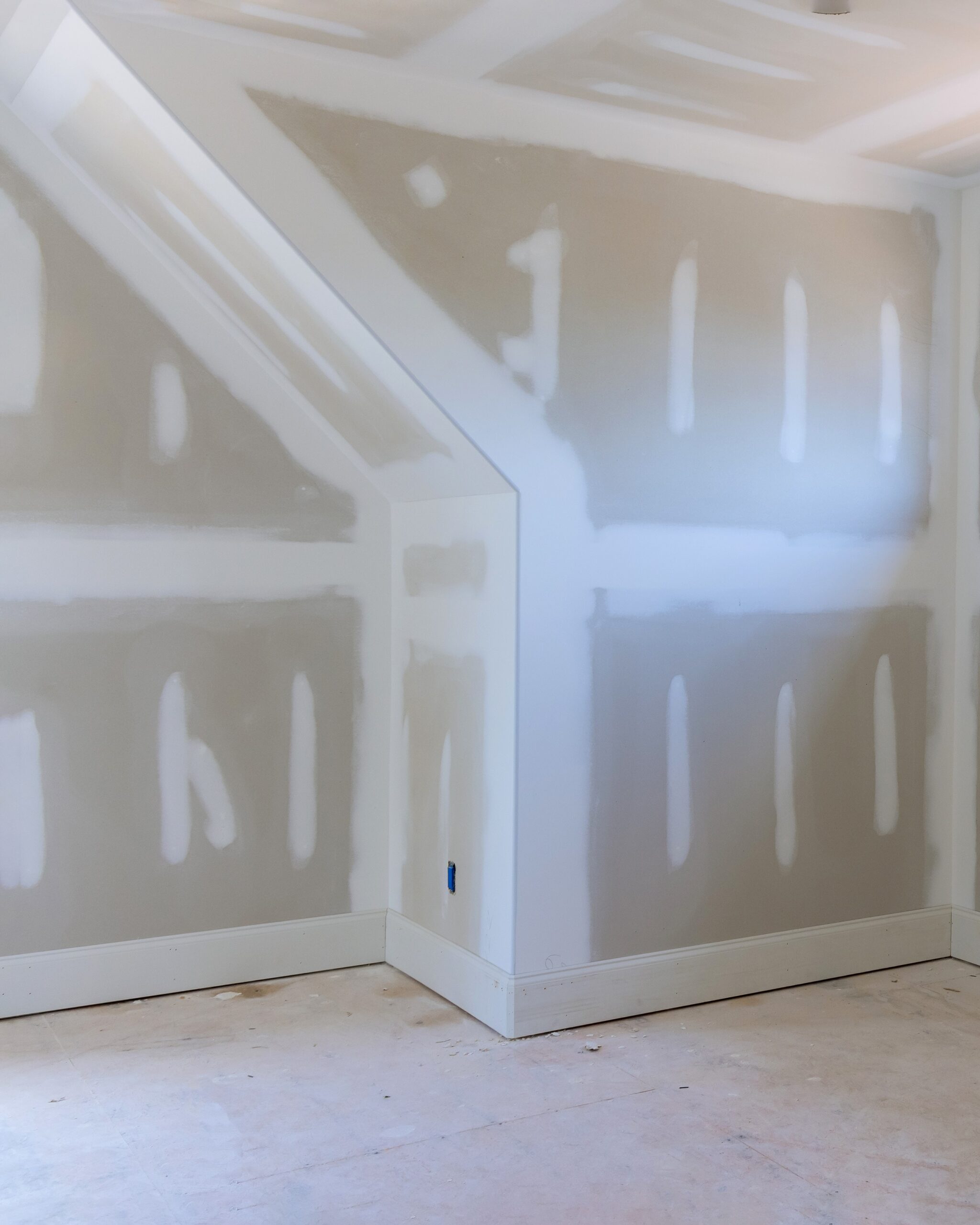 Finishing plastering drywall in ready for paint with new house